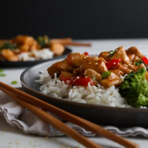 Up close look at chicken coated in a gluten free teriyaki sauce.