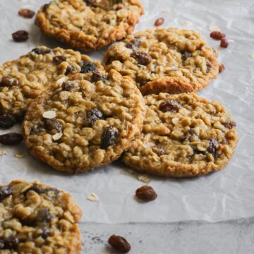Close up view of a pile of gluten-free oatmeal raisin cookies.
